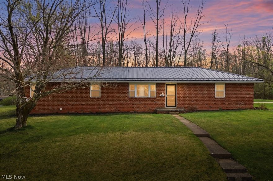 As you arrive, you’re greeted by a clean concrete driveway leading to this well-maintained brick ranch, topped with a newer metal roof that adds both durability and modern appeal. The setting immediately draws you in, offering a scenic view that creates a sense of calm before you even step inside.

Walking through the front door, you’re welcomed into a bright and inviting living space, where fresh paint and updated flooring set the tone for the entire home. Natural light pours in, highlighting the clean lines and thoughtful updates throughout. The heart of the home—the fully remodeled kitchen—truly shines. Imagine preparing meals surrounded by updated finishes, modern touches, and a layout designed for both function and style. Whether you’re hosting friends or enjoying a quiet night in, this space is ready to impress.

Continuing through the home, you’ll find beautifully updated bathrooms with fresh, contemporary finishes, along with newer exterior doors that add to the home’s polished feel. Each room flows seamlessly into the next, creating a cohesive and move-in-ready experience. This property blends modern updates with timeless ranch-style living—ready for you to enjoy from day one.