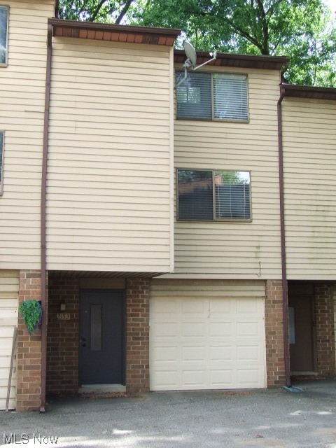 Wonderful condo unit consisting of large living/dining room combo with 2 exposed brick walls, dark wood beams in ceiling with track lighting, sliders to newer deck/balcony overlooking woods and pond. Fully equipped kitchen was updated in 2009 with granite countertops, whitewashed maple cabinets, deep sink, and includes refrigerator, stove, dishwasher and microwave. Up the spiral staircase is the LOFT bedroom with vaulted ceiling and beam, ceiling fan, two doube closets with more storage on top, and more views of the woods and pond. Full bath with some extra storage and uniqe "sunken" tub/shower. First floor has foyer area, laundry room with washer, dryer, utility sink, built-in cabinets and entry to attached 1-car, deep garage with opener and shelves. Living room has gas line that could be used for gas fireplace. Updates include kitchen 2009, roof 2011, hot water tank 2021, furnace 2022, deck 2022. Association allows pets and leasing. Home warranty included.