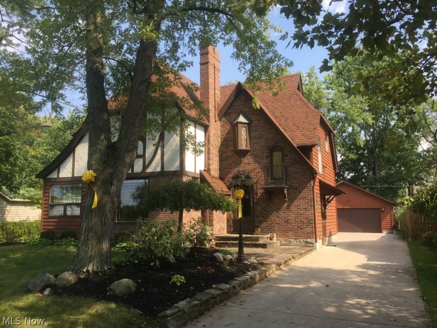 Quality and character abound! This unique 3 bedroom 1.5 bath Tudor home has tons of curb appeal with its brick and cedar exterior and gorgeous landscaping. All original wood trim and hardware! Step into the foyer and into the living room that features crown molding, built-in shelving, and French doors to the sun-room. Formal dining room also has crown molding and built-in cabinets for convenient storage. Original hardwood flooring throughout the home under wall to wall carpeting. Kitchen features ceramic tile flooring, granite counter tops, oak cabinets and all appliances. Second floor has master bedroom and two additional bedrooms, cedar linen closet, full bath with marble flooring and pedestal sink. Full unfinished basement has glass block windows, all 4 walls replaced, newer hot water tank, newer boiler, whole house water filter, and lots of room for storage. Pull-down Attic storage is floored and lighted for extra storage. Back yard features deck, new stamped concrete patio, 2.5 ca
