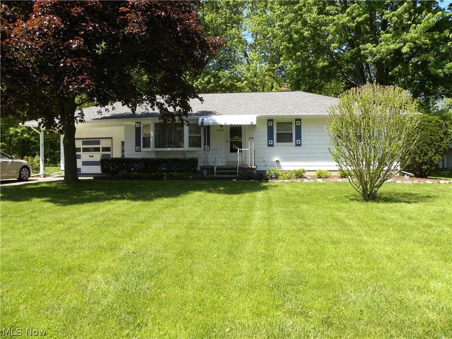 Pride of ownership shows throughout this charming ranch.  Features large living room, country kitchen with eating area. 3 spacious bedrooms and full bath on main level.  Over sized 1.5 car garage, with a 16x12 sun porch attached, relax and enjoy the Tranquil backyard with small creek along the back and overlooks woods.  The full basement is partially finished with a huge rec room featuring a wet bar at one end and fireplace wall and built in seating at the other. Fireplace is electric. There is also a half bath down and over in the laundry area a Large shower.  Many recent updates, include newer roof, new septic system, kitchen flooring.  There is also a large 16x14 Workshop shed, with electric at the back of the property.  Don't miss this great buy located in Elyria Township!