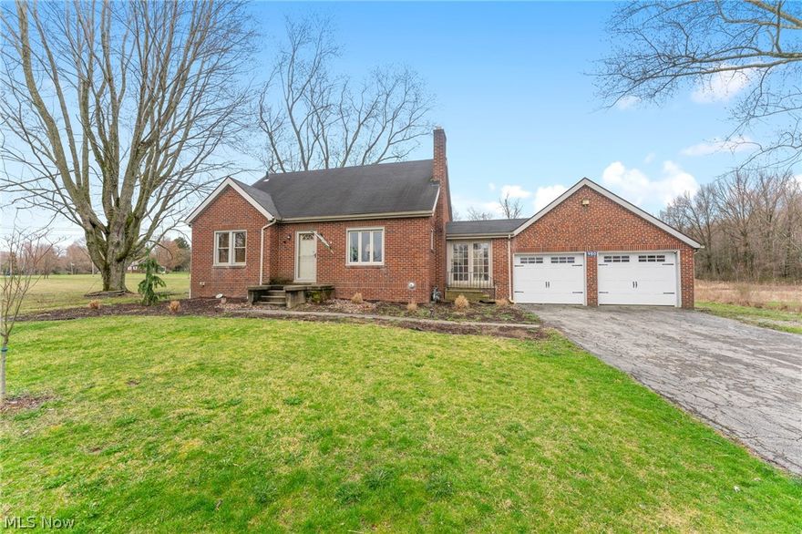 A little bit of city meets a little bit of country here at this brick cape cod on nearly 3 acres. As you enter the living room you will notice the original wood floors and wood burning fireplace, to the left are two bedrooms and the full bath. The dining room has built in cabinets and a sliding barn door that leads to the kitchen. A large bedroom on the second floor with multiple closets. There is a mud room with brick walls, gas heater and a wood ceiling that joins the kitchen to the garage. The two car garage has new doors and a large workshop/3rd bay attached to the rear. In the backyard there is a deck and above ground pool in the small fenced area. Out back you will find the barn and fenced pasture, there are 3 stalls inside. The property extends back into the trees