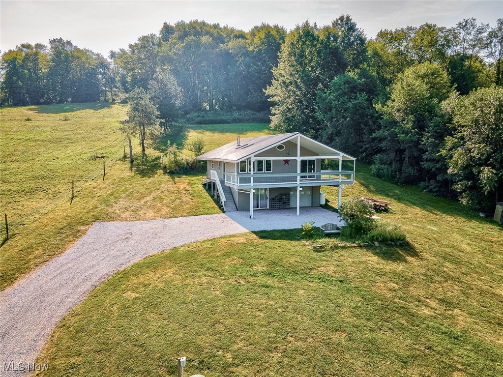 Country Living with Stunning Views! This 3-bedroom, 2-bath home with 5 beautiful acres, most of which are wooded , features a walkout lower level and a massive 36-foot covered second-story deck overlooking picturesque countryside.Inside, you’ll find vaulted ceilings and an open floor plan that creates a spacious and inviting living area. All three bedrooms are generously sized, providing plenty of space for comfort and relaxation. Recent updates include fresh paint throughout, new flooring, and a refreshed deck, making this home move-in ready for its next owners.
If you are a hunter or nature lover, this property is for you. The land is filled with fruit-producing trees and shrubs, including peach, pear, blueberry, strawberry, elderberry, blackberry, raspberry, and chokecherry. In front of the home, a thoughtfully designed pollinator garden adds to the charm with yarrow, bee balm, ornamental onion, dogwood, and lilac. Several small outbuildings are included, such as rabbit and chicken coops—perfect for hobby farming or 4-H projects.
Utilities include Carroll Electric and Salem Propane, with a Rinnai propane on-demand hot water system and an electric furnace and A/C that were recently repaired and serviced. A brand-new septic system was installed in 2021. This unique property blends natural beauty with practical updates—ready for you to enjoy peaceful living in the country.