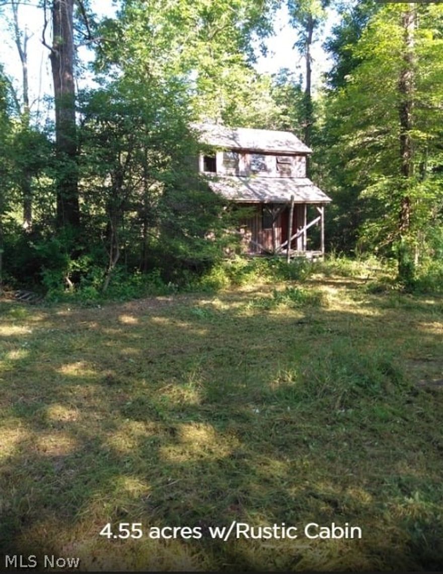 Beautiful  4.55 acres with Rustic Hunter's Cabin! Come enjoy your own little slice of paradise! Stream near cabin, with tons of wildlife to enjoy. There is open frontage near street for your potential dream home, utilities at road; Beyond that, lot slopes down to your wooded private retreat, where cabin and stream await you!  " Interested buyers can contact Ashtabula County Health Department to inquire about taking a test to install their own septic system. "