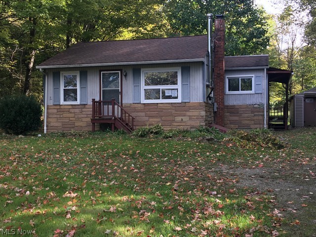Three bedroom home sits on a wooded lot and has an eat in kitchen with maple cabinets, wood floored living room that has a bricked area and the exhaust piping for a woodburner , bath, full basement and outside shed. Third bedroom was being used as a first floor laundry room. Heating system is propane fuel.