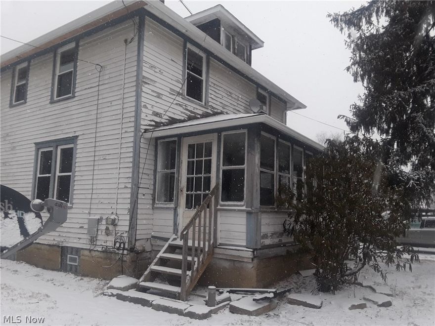 IT'S NOT WHAT IS ON THE OUTSIDE, BUT BEAUTY IS INSIDE...DEFINITELY WITH THIS HOME.  The inside of the home offers cozy, clean, fresh new looking home with many great features. The sun room in the front , the large living room has new carpet, crown molding, and modern look , the dining room offers a formal eating area or could be a casual eating area off the kitchen and is freshly painted, the kitchen is completely remodeled with new cupboards, counters, some new appliances, all have been serviced and ready for a new resident. The L shaped kitchen offers a back entry to home from the entertaining deck, two seat breakfast nook, and first floor laundry (washer and dryer included in listing). The back of home is stamped concreted perfect for barbecues and entertaining, enclosed with a large privacy fence, and sliding doors that lock. The driveway is spacious, enough for at least four cars. This home sits on a corner between the post office and mechanic shop. The home needs some TLC on the