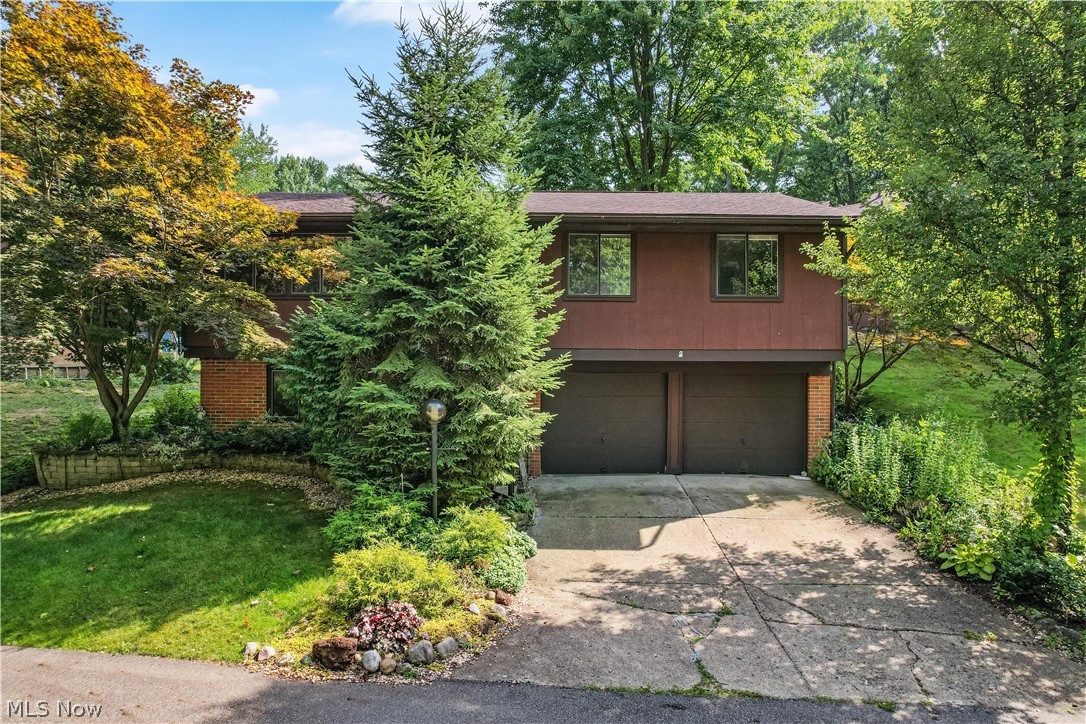 This perfectly positioned with wooded setting condo features additional parking with views of the pond! All 3 bedrooms are on the main level and boast ample closet space. The living room is open to the kitchen and dining area with views of the large enclosed three seasons room, the perfect place to unwind and entertain. The lower finished level includes a rec room, half bath, laundry and walks out to the two car heated and cooled garage. Additional storage under basement steps. New carpeting in living room, hallway and stairs. Newer hot water tank, water softner and A/C. Schedule your showing today!
