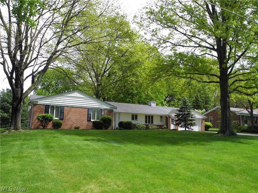 There is a lot to be said about “pride in ownership” and this majestic ranch, in a highly-desired area of Canfield, is a wonderful example.  Built by its current owner in 1960, this 3 bedroom, 2 ½-bath ALL BRICK home offers tremendous curb appeal and craftsmanship.  Formal entry into a slate foyer with nice rich hardwood floors underneath almost 100 percent of the carpet.  (Carpet was laid over the floors three years after the home was built, so one can imagine the condition of the hardwood!)  This home has obviously been maintained impeccably from the day it was built.  Huge master bedroom and two other large bedrooms, all of which boasts huge closets, not to mention numerous areas of storage.  Nice-sized living room with crown molding, through to a formal dining room and into a cute den area.  Nice country kitchen coupled with a main floor laundry area and half-bath.  In the rear of the property there is a beautiful, three-season, screened sunroom, for those nice warm days and evenin