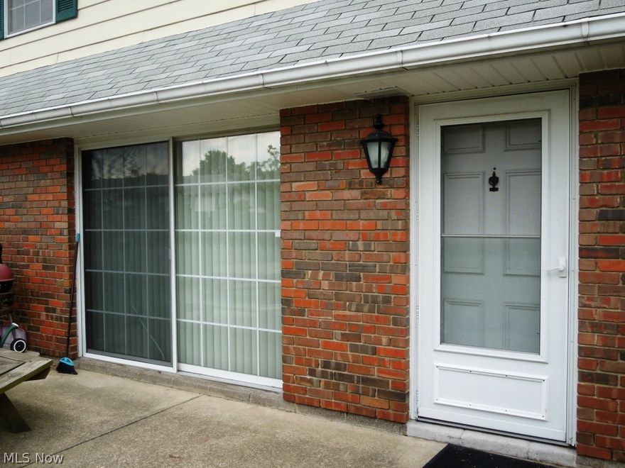 Concrete Patio Courtyard fenced in. Stove, microwave and  refrigerator stay. Walk to Great Lakes Mall, Library, shopping. Entertainment center in living room stays. Maintenance includes heat, gas, water. No gas bills. One year home warranty provided for buyers