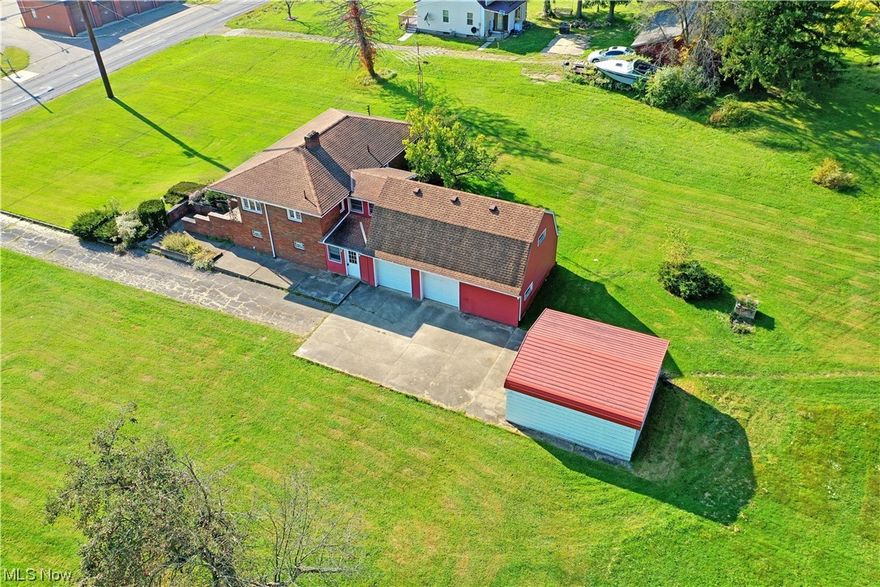 Looking for something a little different? This semi-rural Southington home has just what you’re looking for with its prominent, all brick main floorplan combined with an attached barn style garage complete with finished living space above! Set into the hillside, a triple tier staircase rises to the formal entry way. Meanwhile, the casual side entry finds both the basement level and garage access, each with secondary staircases. Inside, find heavy use of natural woodwork as it trims the doorways and baseboards. Sculpted plaster work is present throughout the illustrious living room with its oversized picture window. Nearby, the handsome kitchen continues with additional hardwood flooring as the central dining area ties back across the main hallway. The pair of welcoming bedrooms are accompanied by a full bath with glass stall shower and built-in cabinet storage. Across from the Nature Stone lined transition, a third potential bedroom awaits the finished loft space or utilize it for other purposes such as rec space or secondary family room. The canvas is yours to create!  NO FHA