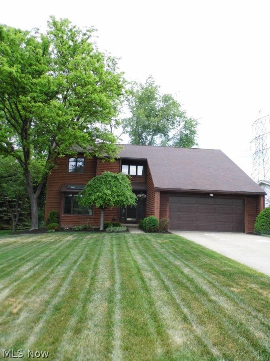 Check out this gorgeous Cedar-sided contemporary in park-like setting!  Beautiful yard & landscaping with huge rear deck looking onto wooded view. Great for cookouts & outdoor entertaining! Dramatic, soaring vaulted space with wood-beamed ceiling in Great Room featuring a floor to ceiling stone fireplace, TWO sets of sliding glass doors to awesome, deck beautiful views. Adjoining dining room has vaulted ceilings, is convenient to the eat-in kitchen, which features oak cabinets, newer countertops, sink with disposal as well as a garden window. A nicely appointed 1/2 bath is right off the foyer entry for great layout. The foyer, kitchen, and 1/2 bath all feature hardwood floors. First floor Master Suite with a bonus room currently used as a nursery; could be a cozy home office or #2 Walk In closet! The very large master suite also features a dual bathroom with separate sink area and shower/toilet room and a huge walk-in closet with storage organization system. Upstairs are two LARGE bedr