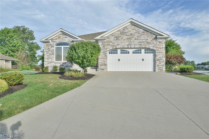Lakefront Paradise of the "SHORES" by Lake Evans. With Immediate occupancy you can have your dream come true.  The stacked ledge stone front, is inviting you to enter this open floor plan which from the front looks like a Ranch, but the Lower Level gives you much more than you expected.  Stacked Sand Stone Floor to ceiling gas Fireplace in the Great Room. 10' ceilings, rounded corners and oversized moldings are upscale customized finishes, Granite Kitchen Counters, the Island has captured your kitchen.  Eating bar and black stone double sink in the Island.   Top of the line Stainless Appliances.  Copper colored and glass back splash.  Island Cabinets Darker tone with wall cabinets in vanilla.  Looking from any room the picture windows, WOW what a view and two balcony's can be stepped out to from the Dining Room and Great Room.  Speakers throughout with volume control in each room.  Huge Master with an on suite, double bowl sinks with granite counter.  Radiant heated floor in the Master