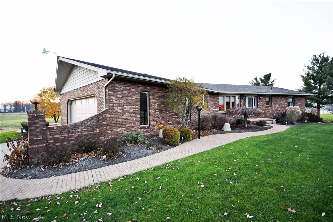 Beautiful brick ranch in peaceful rural setting, close to 2 acres! First floor living with spacious open floor plan and full 2 story to the back of the house! Vaulted ceiling and abundant windows give this home an open and airy feel. Fabulous kitchen with breakfast bar, walk in pantry and walk-out to a small deck. Spacious dining room great for hosting large groups. Large first floor bathroom with double sinks, updated tile shower & powder area. First floor laundry & half bath. Neutral decor, nothing to do here but move in! Finished lower level with large rec room with walk-out to deck, family room, 4th bedroom, full bath and kitchenette area. Lower level also includes large workshop with separate walk-out. Garage is oversized with an oversized 8'x18' overhead garage door. No worries as this home comes with America's Preferred Home Warranty! Solid construction with so many features and upgrades. Don't miss out, call today to schedule your showing!