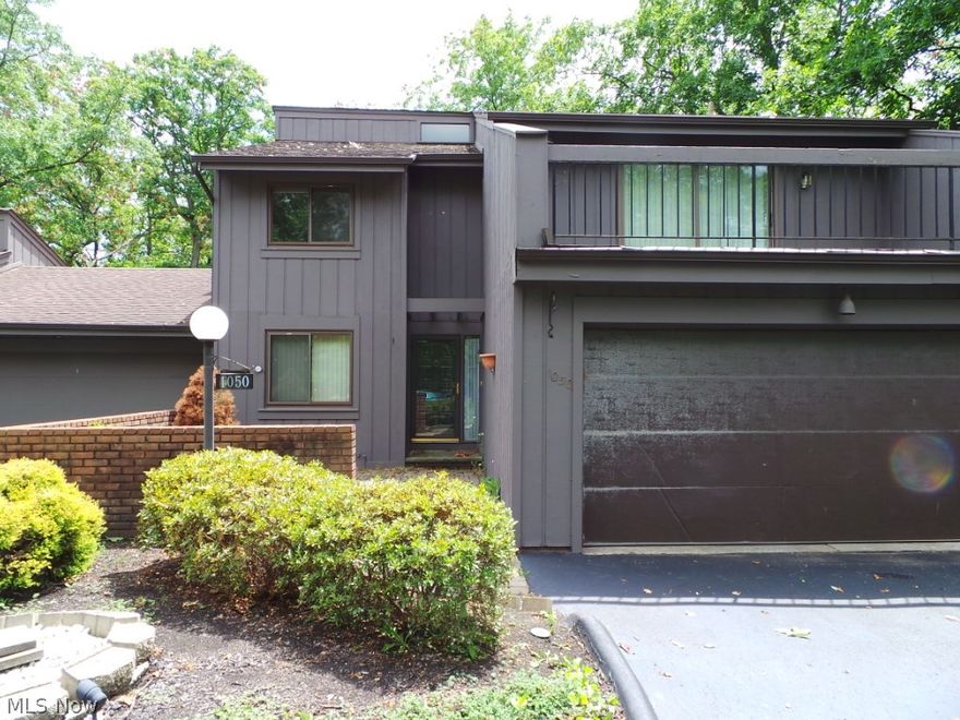 Backs into the Cuyahoga Valley National Park with a wooded canyon view.  Enjoy the amenities of Greenwood Village (in door/out door pool, tennis, pond, club house, water fall, hike and bike trails). Cedar side townhome/colonial with a court yard, deck, patio. WALK OUT finished, carpeted LOWER level w/ storage rm or office, rec.rm, full bath rm., slider to patio. KITCHEN with granite counter tops, hardwood (laminate) floor, oak cabinets and appliances. FIRST floor laundry rm w/ stationary tub, cabinets . FORMAL dining rm. L-SHAPED, 2 sty Great Rm. w/ log or gas fireplace, wet bar.  T-shaped MASTER BEDRM w/ full bath,double mirrored closets. LOFT, carpeted , wrought iron railing overlooks Great Rm.  Property is being sold AS IS. No repairs or credits from seller.