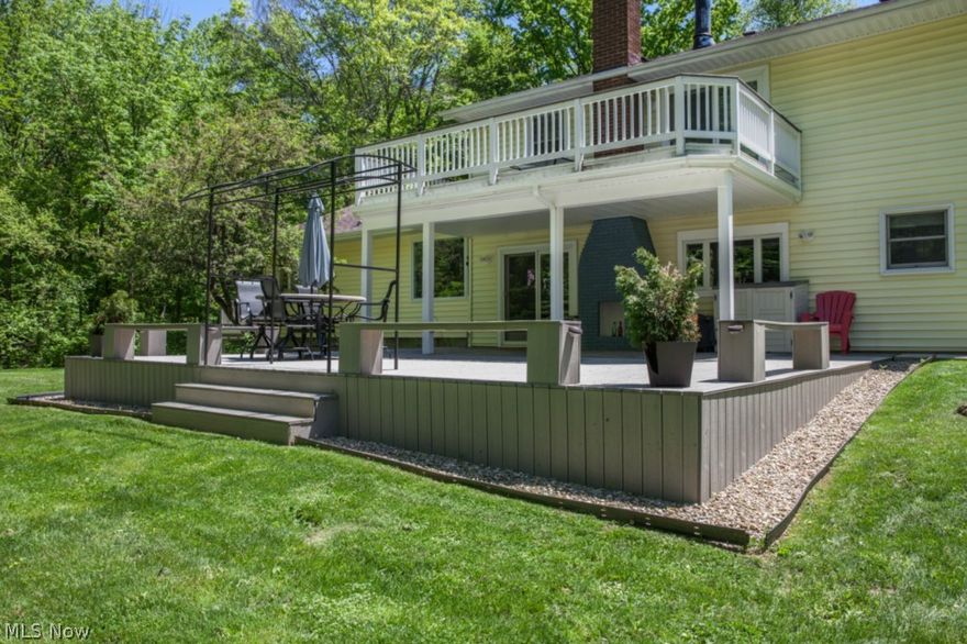 LOOK INSIDE and see the amazing features found in this completely remodeled home on 4.68 wooded & private acres, additional 2 car outbuilding provides workshop or studio space, 4 car total garage capacity. Radiant Heated travertine tile floors are featured in dream kitchen, along w/ maple cabinets, dual oven & cooktop, glass door pantry, huge island with seating & vegetable sink, SS appliances stay, Kitchen w/ access to back patio & outdoor fireplace. Vaulted 26x26 great room includes corner heatilator wood burner which cuts down heating costs, Pergo xp floor ('14),  plenty of space for dining, sitting & media areas, & leads to trex deck w/ stunning panoramic view. Owners suite features raised hearth Gas Fireplace, walk-in closet w/ built in organization & Sun Deck. Luxurious Owners private bath features oversized porcelain tiled shower & floor, double vanity, & effervescent (air jetted) tub. Two additional generously sized bedrooms measure 16x10. Guest Bath features large tiled shower