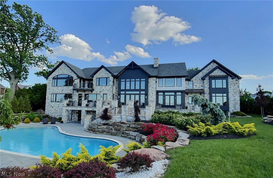 This architectural masterpiece boasts breathtaking views of Lake Erie with tasteful exquisite details throughout. State-of-the-art dream kitchen with a butler’s pantry outfitted with top-of-the-line appliances. Private dining room ideal for hosting the most lavish dinner parties. Dreamy primary suite with a private balcony and a tranquil bath featuring a freestanding tub overlooking the lake. In-law suite equipped with a full kitchen. First floor guest suite. Walk-out lower level with a full bar, rec room, exercise room, and if you love sports, you are in for a treat! Outside features meticulous landscaping with exotic flowers, waterfalls, multiple limestone patios, phenomenal in-ground pool, hot tub, outdoor kitchen, and fire-pit. All of these luxury amenities hardly offers the residents a reason to leave. This is a must see! Smart home technology with security, exterior professional lighting system, indoor & outdoor sound system, & more.