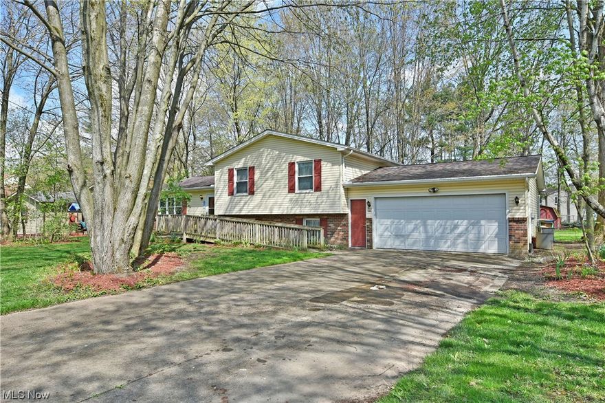 With it's tree lined lot and desirable Cortland location, this split level home offers tons of potential with its four levels of finished living space! Currently configured for limited mobility access, the residence has a concrete drive that leads to a two-car garage with additional storage available out back courtesy of a large shed. Inside the home, a prominent foyer opens with dark, hardwood styled flooring that fills the nearby living room. Natural light pours from the three picture windows, helping to illuminate adjacent formal dining. The kitchen updates in 2021 include newer tiled flooring, refrigerator, stove, microwave and dishwasher. The stainless appliances meld perfectly with the stone-look countertops and complimenting backsplash. A chair rail and crown molding accent the chimney, extending from the lower family room. Upstairs, three welcoming bedrooms join a tasteful full bath updated in 2022, with the same treatment given to the second full bath in 2022 in the larger mas