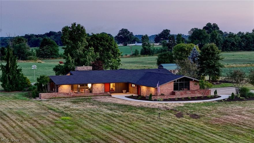 Fall in love with this Magical Mid-Century Modern Ranch!! Home has been Lovingly Restored by Current Owner as a Forever Home. Nestled on 6 acres back off Center Road in Columbiana County. Greetings are met at the Foyer Overlooking the Living Room, Dining and Kitchen. Living Room with its Proud Exposed Beams, Vaulted Ceiling and abundance of floor to Ceiling Windows and Glass Doors, make for an engaging environment. A Striking large Fireplace separates the Living Room from the Formal Dining Room. Cozy up in Conversation with a Firelight Dinner while Surrounded by Nature. Remade Kitchen with its High End Appliances, Quartz Counters, Cherry Wood Flooring, and Seamless Cabinetry exemplify both Function and Style. Island with Twin Skylights positioned above the Workspace amplifies extra daylight and warmth into this location. Tucked away awaits Sleep and Slumber with 3 Bedrooms and 2 Full Baths. Primary Bedroom Boosts its own en-suite and entry to the Back Patio. First Floor Laundry directly off Attached 2 Car Garage, also a work of Art on its own. Plenty of Storage in the Full Basement. Architect Albert J. Sgro designed with the Inspiration from the Great Frank Lloyd Wright. "Relationship of the Human Being to Space and Space to Nature" Many, Many Updates and Delights. A Few to Mention: Well, Roof, Skylights, Cabinetry, Counters, Paint, Walkway, Water Softener, Wool Carpets, Bathroom Updates, Electric and so much more. Seller is also offering a Home Warranty. Full List of Updates and Venders Available. Call your Favorite Agent to take you through this Beauty Today.