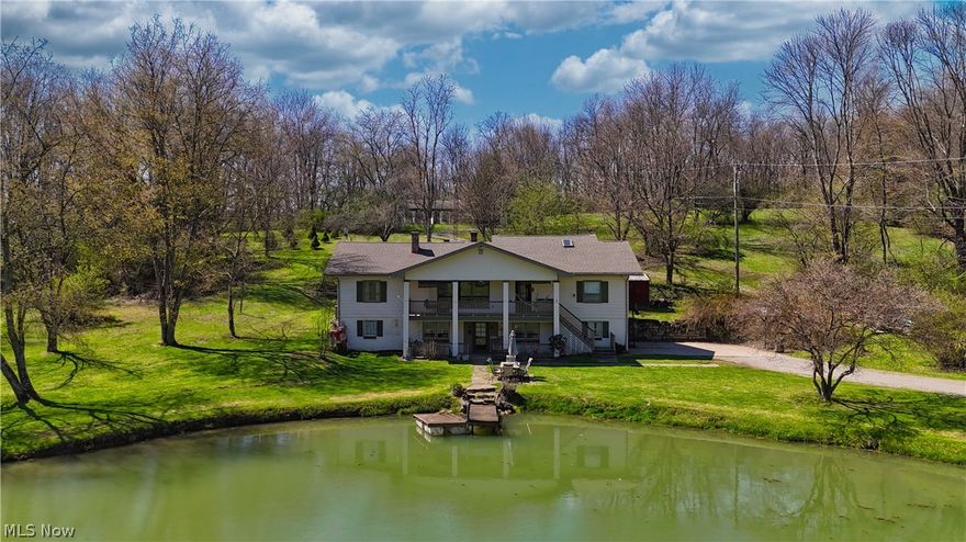 Welcome to your private country retreat on over 12 picturesque acres in St. Clair Township, located within the Beaver Local School District and just minutes from the Pennsylvania and West Virginia state line. This exceptional property offers a rare combination of space, functionality, and scenic beauty, complete with a stocked koi pond, expansive outbuildings, and endless possibilities. The main level of the home features three bedrooms and two full bathrooms, along with a spacious living room highlighted by a cozy fireplace. A formal dining room offers its own fireplace and built-in cabinetry, creating the perfect setting for gatherings. The kitchen includes a pantry and provides access to two covered rear decks, ideal for relaxing or entertaining. Just off the living room, a large covered front porch overlooks the serene pond, offering a peaceful place to unwind. Upstairs, you’ll find two additional bedrooms, including a pass-through bedroom and extra storage space. The fully finished walkout basement expands the living space with a family room featuring a fireplace, a full bathroom, laundry room, utility room with workshop area, and an attached two-car garage. Step outside to a covered patio at ground level, perfectly positioned near the pond for easy outdoor enjoyment. Outbuildings abound, including a detached wood shop or playhouse located just behind the home, a large red barn recently stained in 2024, and a detached garage adjacent to the barn—ideal for hobbies, storage, or equipment. A standout feature of this property is the expansive dog kennel facility, offering 26 runs, oil heat, wall air conditioning units, a cat room, grooming room, half bathroom, and its own separate 100-amp electrical service—perfect for breeders, trainers, or animal enthusiasts. This one-of-a-kind property offers a unique opportunity to enjoy country living with incredible versatility—whether for a hobby farm, business venture, or private estate.