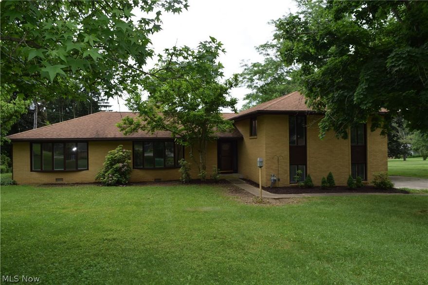 Northwood Subdivision. A spacious 4BR brick home located in one of Zanesville's most prestigious neighborhoods. This home offers new hardwood floors throughout. This home has a beautiful formal living room that is open to the formal dining room which makes it perfect for entertaining. The large kitchen is open to the family room and there is a second family room on the lower level. The master suite features a spacious bedroom, dressing room, and a full bath. The three additional bedrooms each have large closets. The roof is only 10 years old. The spacious two car garage is heated and there is plenty of room for storage. The driveway is concrete w/turn around. The back patio also has a pergola. A large level lot. Short distance to Zanesville Country Club, shopping and medical facilities. Turn this blank canvas into your very own masterpiece.  The possibilities are endless. This quality, solid brick home is priced well below market value for a quick sale.