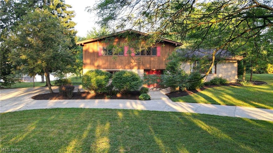 Been dreaming of a sprawling home with a park-like yard that overlooks a beautiful lake? This is it! Welcome Home to 161 Center Street located in the heart of Seville. This beautiful home is nestled on almost 1.5 scenic acres & backs up to a fully stocked lake that you have ownership in. This 4 level split has over 3900 finished sq ft.  

As you pull into the drive w 2 entrances, your eyes can’t help but be drawn to the bright red front door. Through this door you’ll find yourself in a foyer that leads to a cozy living rm w wood burning fireplace & impressive glass doors that lead out to the expansive decks. Choosing which stairs to ascend will determine if you find yourself in the kitchen or in the naturally-lit great room w its soaring ceilings & charming wood beams. The master suite awaits you upstairs & even has its own balcony! 2 more extremely large bdrms & full bth complete upper floor. There are 2 more lower levels to explore! Finished lower level consists of a bar, wood burn