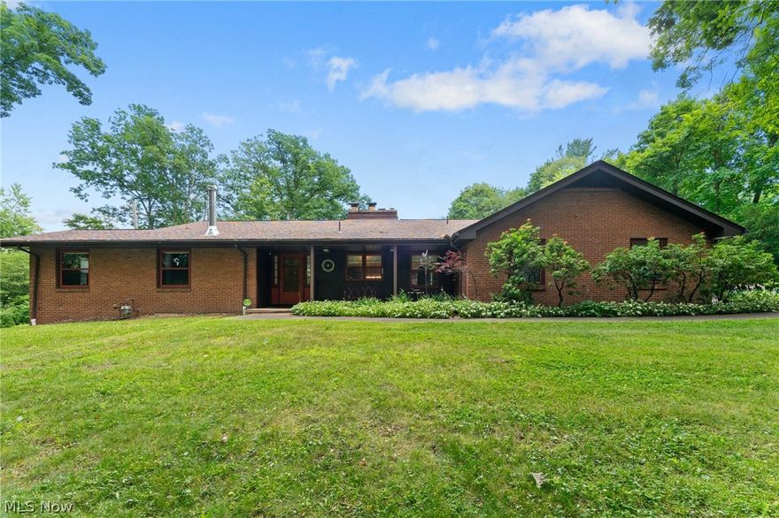 This beautiful brick ranch offers an abundance of features, making it a one-of-a-kind opportunity you won't want to miss. Situated in a private, park-like setting, the property exudes a welcoming ambiance from the moment you drive up. Enter through the side into a charming, enclosed porch that overlooks a fenced-in area complete with an inground pool and ample space for poolside furniture, perfect for summer relaxation and entertaining. Through the double doors, you'll find yourself in an expansive space that seamlessly combines the dining room and family room. This area is breathtaking with its hardwood flooring, an impressive brick fireplace, custom built-ins, and plentiful storage throughout. The kitchen, located at the front of the house, features warm wood cabinetry, quartz countertops, and a ceramic tile backsplash, providing a cozy and functional space for cooking. The first floor also boasts a spacious master bedroom with an adjoining office or den featuring two double closets. The full bathroom includes a large soaking tub and a walk-in shower with ceramic tile, ensuring a spa-like experience. Another bedroom with two double closets adds to the home's ample sleeping quarters. An in-law suite addition includes a large bedroom with a walk-in closet and a full bath, providing comfort and privacy for guests. The convenience of first-floor laundry adds to the home's functionality. The basement, with two stairway accesses, is partially finished and waterproofed, featuring a bar area, kitchenette, and another brick fireplace, making it an ideal space for entertaining. A 4th bedroom near a full bath updated. An attached two-car garage and an outbuilding with a detached oversized garage. The expansive yard provides room for outdoor activities and gardening. Enjoy the convenience of public water and sewage services. Located in the Hubbard School District. Don't miss the chance to make this exceptional property your own!