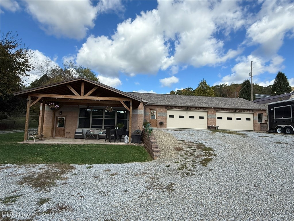 Custom 3 bedroom, 2.5 bath home in New Phila Schools.  Fantastic open floor plan with vaulted ceilings, stone accent wall and wood laminate flooring.  Quality, Kraftmaid kitchen boasts granite counters, island breakfast bar, walk in pantry and stainless steel appliances.  Private 2nd floor master suite with walk in closet and full bath featuring marble top vanity.  Barn sliding doors access the 2 main floor bedrooms and full bath with steam shower.  Enjoy the peaceful, scenic setting from the stamped concrete, covered front porch.  32 X 50 (6 car) attached garage includes heating, a/c and half bath.  12 X 20 storage shed with electric.  This one of a kind home is a must see!