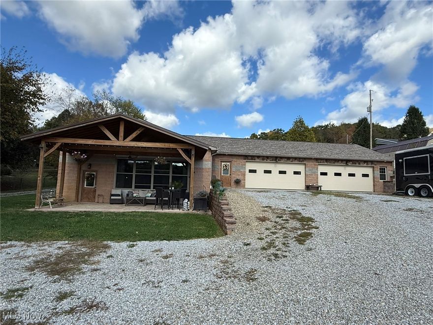 Custom 3 bedroom, 2.5 bath home in New Phila Schools.  Fantastic open floor plan with vaulted ceilings, stone accent wall and wood laminate flooring.  Quality, Kraftmaid kitchen boasts granite counters, island breakfast bar, walk in pantry and stainless steel appliances.  Private 2nd floor master suite with walk in closet and full bath featuring marble top vanity.  Barn sliding doors access the 2 main floor bedrooms and full bath with steam shower.  Enjoy the peaceful, scenic setting from the stamped concrete, covered front porch.  32 X 50 (6 car) attached garage includes heating, a/c and half bath.  12 X 20 storage shed with electric.  This one of a kind home is a must see!