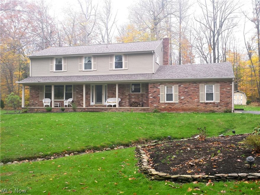 Move right into this traditional colonial on 1+ acre tranquil, wooded, setting.  Many updates including cherry kitchen, Corian counters, tiled floor, stainless appliances & bayed dinette that overlooks yard.  Kitchen flows into family room with brick fireplace, hickory flooring, & slider to deck. The formal living and dining rooms are light, bright, with hickory flooring. The foyer boasts newer door, sidelights, and slate flooring that extends into the powder room. The laundry room is conveniently located off the garage. Upstairs is a spacious master suite with updated bath that features whirlpool tub.  3 additional bedrooms share main bath with dula sinks; newer carpet [2016]. 2 finished rooms in basement make great playroom & office.  Other recent updates include boiler, hot water tank, windows, garage door, deck, roof & vinyl siding. Pilgrim Village is a beautiful lake community with lake, beach pavilion, & volleyball court.