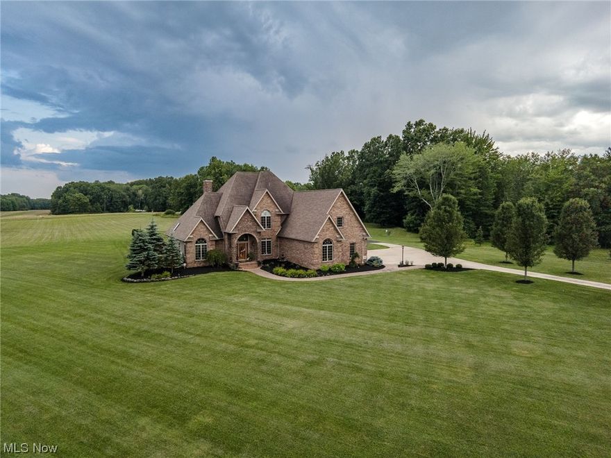 A luxurious estate offering 3-4 BD/3.5BA/3-CAR attached garage & an additional 3700 sq.ft. outbuilding. This one-of-a-kind home is located in Vienna Twp./Mathews School. 9 acres of comfort & tranquility.  The interior offers hardwood flooring, grand trim, & brilliant warm tones. The kitchen features an island, custom cherry cabinetry, & granite countertops. The GR is accentuated by a stone gas FP. The main floor MBR features a MBA w/a jetted tub, stand up shower, custom tile, & heated floors! The 2nd floor BA boasts the same. 2-3 BDRMS can be found upstairs. The BIG bonus room can easily be a 4th BDRM. The finished basement includes a 2nd kitchen/wet bar & full BA. Plunge into the heated pool with waterslide & enjoy the the outdoor FP. The covered stamped concrete patio is perfect for entertaining. Take comfort utilizing the outdoor bath house. The insulated, heated & finished outbuilding is equipped with (2) 14ft. doors, a 40ft. wide hangar door, 220 electric & water & can fit up to 17 vehicles. FREE GAS is available.