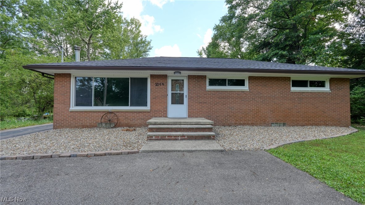 Welcome home to this charming brick ranch nestled in the desirable Green Local School District! Boasting three bedrooms and two bathrooms, this home is designed for comfort and convenience. The inviting eat-in kitchen provides a cozy space for meals, while the spacious living room features a stunning Buck Wood Stove fireplace and a large picture window that floods the space with natural light. Large partially finished basement with a full bathroom. Step outside to the expansive deck, perfect for relaxing while overlooking 0.69 acres of breathtaking views.
This property is packed with updates, including a new roof (May 2024), updated landscaping featuring a beautiful small pond (Summer 2024), and a freshly built deck (August 2023). A well pump and bladder tank were replaced in September 2022, accompanied by a chem-free water treatment system installed in January 2023 for added peace of mind. The fireplace has been replaced with a Buck Woodstove (November 2024), offering both warmth and rustic charm. A turnaround driveway added in July 2022 enhances accessibility, while Drylok basement sealing (April 2025) and updated house gutters (2023) ensure lasting durability.
Outside, the clean garage includes a convenient attached work shed as well as a potting shed for additional storage or gardening tools. Inside, the basement, first-floor bathrooms, and first-floor laundry have been recently remodeled, making this home move-in ready. Don't miss out on this gem—schedule your showing today!