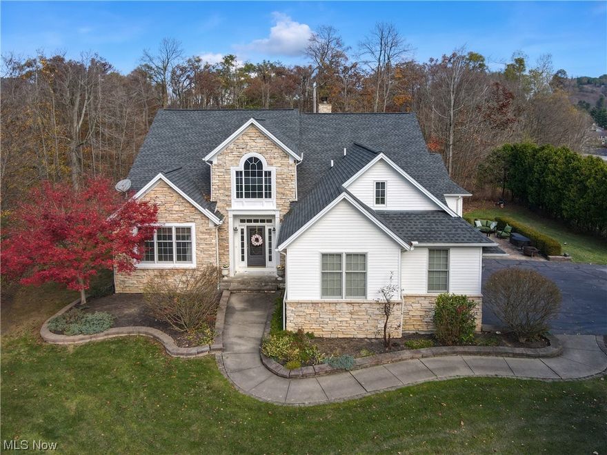 Welcome to this stunning and well-equipped home on a corner wooded lot, providing a scenic and private setting. The two-story great room adds a sense of grandeur and spaciousness to the home.Built-ins in the great room suggest both functionality and a touch of elegance. Beautiful hardwood floors thourghout most of the home add to the ambiance. The recently renovated white kitchen is a focal point, featuring a farm sink, gas range, extra large breakfast bar and KraftMaid cabinetry, known for its quality and durability and quartz countertops bring a luxurious feel.
The first-floor master suite adds convenience and luxury to the home, providing a retreat-like space.
Three large bedrooms and two full baths on the second floor offer ample space for family or guests.. A bonus room on the second floor serves as a versatile space for either an office or playroom or just extra storage space. The finished basement with high ceilings provides extra room for entertaining.  A lovely deck and patio extend the living space outdoors, creating opportunities for relaxation and entertaining. The extra-large three-car garage with a back extension for storage caters to practical needs. The dedicated 220 line for electric EV charging aligns with modern energy-efficient considerations. This home combines aesthetic appeal with practical features, making it a comfortable and sophisticated living space.