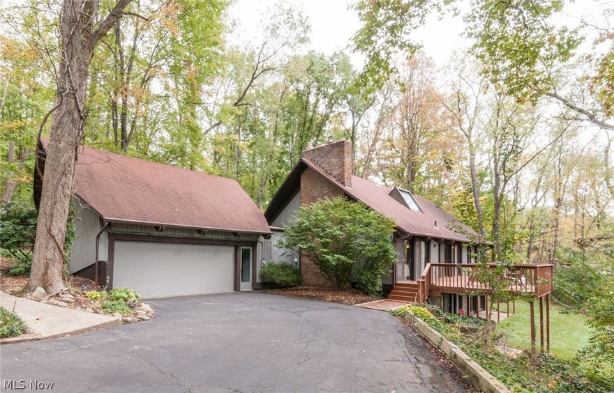 Private & Serene. This completely remodeled contemporary home situated on a 1.5 acre private lot is a nature lover's dream. Natural light floods the interior space through the many extra-large windows. Open floor plan is perfect for entertaining a crowd or just a few friends. The great room features a soaring 20’ vaulted ceiling, hardwood floors, and floor to ceiling brick fireplace w/ wood burning stove insert. The hardwood floors continue into the gourmet kitchen featuring all new stainless steel appliances, soft close cabinets, massive 11’ x 4’ island w/ granite countertops. Walk-in pantry. First floor laundry. Large master bedroom w/ vaulted ceilings, bamboo floors, private balcony, and walk-in closet. Master bathroom complete with dual sinks, granite countertops, and big skylight above bathtub. Relax outside amongst the trees on the full length deck. Revere Schools. Very private yet close to shopping, restaurants, parks and highways. You have to see this house to truly appreciate