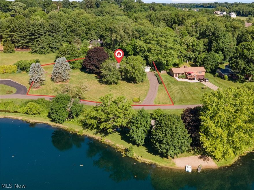 This lovely, spacious mid-century home in Jackson Twp. is situated perfectly for enjoying the beautiful views of Pin Oak Lake along with all the fun that comes with lakefront living including kayaking, paddle boating, fishing and picnicking.  Walk in from the main entry and relax in your family room with a lake view, bamboo flooring and wood burning fireplace (this room could also be used as a dining area).  There is a full bath with walk-in shower adjacent to the family room for your convenience.  A few steps up you will enter the tastefully remodeled kitchen with granite countertops, stainless steel appliances, 5 burner gas stove, shaker cherry cabinets, ceramic tile floors and a custom built-in nook for dining. The Great room overlooks the kitchen and family room which is one of the incredibly unique features of this custom built home.  In the upper level you'll find 3 bedrooms with wood flooring and 1 bath with tub/shower combination updated with tile surround. There is a huge recr