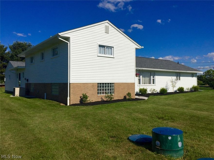 Four bedroom 2.5 bath home with 1,988 sq. ft. located on 2.04 acre corner lot in Marlboro Twp.  Built 1961.  Home features kitchen with appliances open to dining and living room combination with picture window, main floor 4th bedroom currently used as office, family room, half bath, walk in coat closet.  Large main floor owner’s suite (previously in-law suite, could be converted back) with private shower bath and walk in closet.  Two additional bedrooms and updated full bath on upper level.  Partial basement with laundry hookups and glass block windows.  Electric heat pump and central air, forced air oil back-up.  New carpet and vinyl flooring, fresh paint inside and out.  Aeration septic new in 2013, drilled water well, new shingles fall 2015.  Attached two car garage.  Spacious side and back yards, fresh landscaping.  Marlington Schools.  Agent owned.