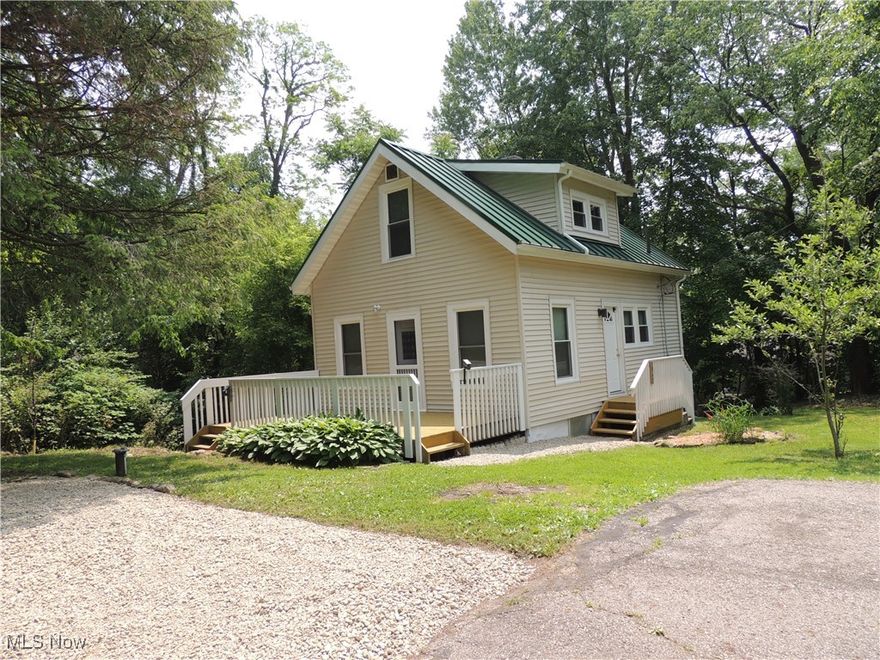 Located in rural Franklin Township this cozy bungalow is situated at the dead end of the street on a sloped lot with many fruit trees, berry bushes, grapes vines and flowers. This home was built as a two bedrooms, but now has a third bedroom in the walk out basement level.   The parklike setting is very serene and private. The updates in the last 5 years include: Metal roof, windows, electric heat pump and central air.  Plumbing and electric in entire home were all replaced in late 1990s. Very low maintenace home. This is a true one of a kind property tucked back off the beaten trail.  Feels rural yet close to city schools and shopping.