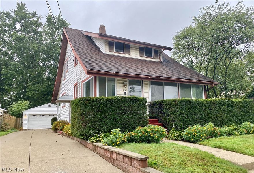 Welcome home to the perfect yard! Recipient of the Akron Beautification award the past 18+ years, this Ellet double lot boasts a large enclosed front porch with stained glass door, back deck, patio with fire pit, 2-car garage and a unique 12x24-foot insulated outbuilding with electric, cable, gas heater, air conditioner and its own covered porch. This Ellet home comes with all appliances including gas range, washer/dryer, dehumidifier, and two standup air conditioners. The hot water tank was replaced in 2017 and the interior of the home was painted this summer. Original hardwood flooring runs throughout the first floor under the carpet and the original claw foot tub has been refinished upstairs. Enjoy walking distance to the elementary school, high school, parks, shopping and dining. The perfect house to make your home with a few cosmetic touches!