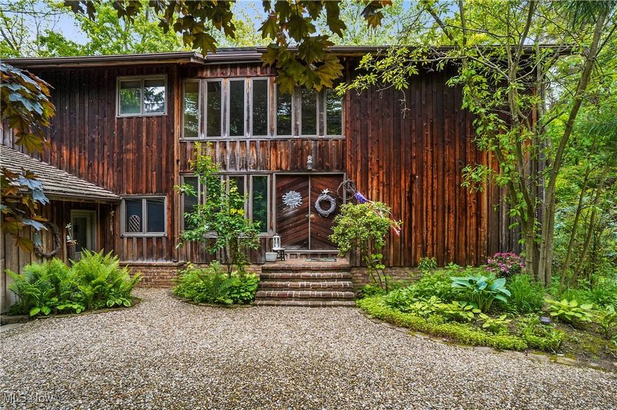 Become one with nature with this uber private, one-of-a-kind cedar build home on 4.5 wooded acres at the end of winding, private drive in Bath Township. Designed by local architect Jerry Ryba and custom built by Loren Lapp, this 4 bedroom, 2.5 bathroom nature-lover’s paradise is perfectly secluded, but ideally located minutes from all that the Montrose/Fairlawn area has to offer. Two story foyer with open staircase leads to impressive great room with expansive, floor to ceiling windows, wood burning fireplace, and entertainment wall. Spacious kitchen features large center island, ample storage and prep areas, full suite of appliances, breakfast nook with an abundance of natural light, nearby dining room, ½ bath and laundry. Cozy, private living room and adjacent office with built-ins complete the first level. Master bedroom features large windows and glamour bath with tiled shower. Three more generously sized bedrooms and a full bath with double sinks and tub/shower combo make up the second floor. Bright and open lower lever with wood burning fireplace, access to outside, billiards room, workout room, workshop, utility area, wine storage, and access to garage. Exterior highlights expansive decking, gazebo, stone terrace gardens and walkways, outbuilding, basketball court, and playset. Notable highlights/updates inc: central vac system, 300 amp elec panel (24), 80 gal hot water tank (22), gutter guards, Andersen windows, multiple skylights, and transferrable mineral rights. Award winning Revere School District. Don't miss this great opportunity to own one the areas premier, private retreats.