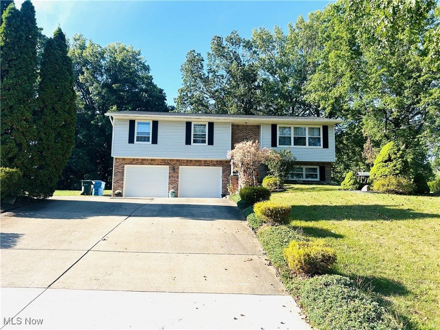 What a great location, minutes from the Target Plaza and easy access to I-77. You will be amazed by this peaceful, over 1/2-acre large backyard, surrounded by fruit trees, hammock, shed(14x12), soccer field and a playset (staying). This beautifully decorated home offers not only so much natural light, but it gives a feel of an open concept. Enjoy your morning coffee at the breakfast bar or the deck area overlooking this meticulously maintained backyard. The owners worked hard on all updates. You will love this custom-made Cherry Wood kitchen with quartz countertops (2021), along with stainless steel appliances (2021). 3 bedrooms are conveniently located on the 1st level. The Master Suite overlooks the backyard, and it features a remodeled glass shower bathroom with modern mirror, tile and vanity. All 3 bedrooms are very cozy and well decorated. Front foyer entry steps and all flooring feature LVT, giving this home a very modern look. Lower-Level features easy access to garage, filled with much storage space and hooks for all the coats and bags. Lower-Level Playroom is also used as an office, and the above grade windows give much natural light. You will love this lower-level full bathroom, connected to the laundry room and the storage area. Some of the most recent updates feature Roof (2020), two complete bathroom remodels (2023), flooring (2020), front door and railing (2024), garage doors and complete garage door system with camera (2024), fresh paint (2024), hot water tank (2019), water softener (2020), new water pressure tank (2025), reverse osmosis (2024), whole house humidifier (2019) and well pump (2018). The location of this home is superb, only a minute to the docks of Portage Lakes, winery, bowling alley and many more amenities of this centrally located and gorgeous home in Green!