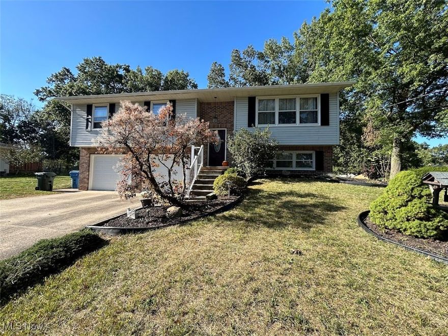 What a great location, minutes from the Target Plaza and easy access to I-77. You will be amazed by this peaceful, over 1/2-acre large backyard, surrounded by fruit trees, hammock, shed(14x12), soccer field and a playset (staying). This beautifully decorated home offers not only so much natural light, but it gives a feel of an open concept. Enjoy your morning coffee at the breakfast bar or the deck area overlooking this meticulously maintained backyard. The owners worked hard on all updates. You will love this custom-made Cherry Wood kitchen with quartz countertops (2021), along with stainless steel appliances (2021). 3 bedrooms are conveniently located on the 1st level. The Master Suite overlooks the backyard, and it features a remodeled glass shower bathroom with modern mirror, tile and vanity. All 3 bedrooms are very cozy and well decorated. Front foyer entry steps and all flooring feature LVT, giving this home a very modern look. Lower-Level features easy access to garage, filled with much storage space and hooks for all the coats and bags. Lower-Level Playroom is also used as an office, and the above grade windows give much natural light. You will love this lower-level full bathroom, connected to the laundry room and the storage area. Some of the most recent updates feature Roof (2020), two complete bathroom remodels (2023), flooring (2020), front door and railing (2024), garage doors and complete garage door system with camera (2024), fresh paint (2024), hot water tank (2019), water softener (2020), new water pressure tank (2025), reverse osmosis (2024), whole house humidifier (2019) and well pump (2018). The location of this home is superb, only a minute to the docks of Portage Lakes, winery, bowling alley and many more amenities of this centrally located and gorgeous home in Green!