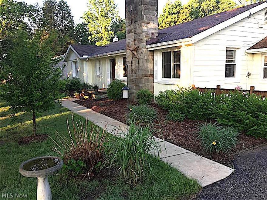 A Perfect Paring - N. Perry Amenities and this Wonderful Home with Open Floor Plan on over 2.5 Acres! This Remodeled Ranch Home boasts natural light through out. The Spacious Living Room with Gas Fireplace has been Opened up to The Dining Room and Kitchen and Accented with Cedar Beam, Hardwood Floors run though the Kitchen, Dining Room, Living Room and Oversized Bedrooms with Large Closets. The Master Bedroom has a Private Full Bathroom and Triple Closets. Kitchen with Breakfast Bar and Newer Appliances has plenty of counter space and cabinets to delight any chef! Full Basement with Rec Room and Half Bath offers many possibilities for storage or additional living space! Beautiful 2.72 acre lot has wooded area with creek and backs up to a nursery. Heated, Attached Garage has room for more storage. Don't miss the Mudroom and Covered Patio plus the many updates: Bathrooms, Furnace, HWT, Windows, Electric, Flooring throughout, light fixtures, trim, landscaping, and more…come view your new