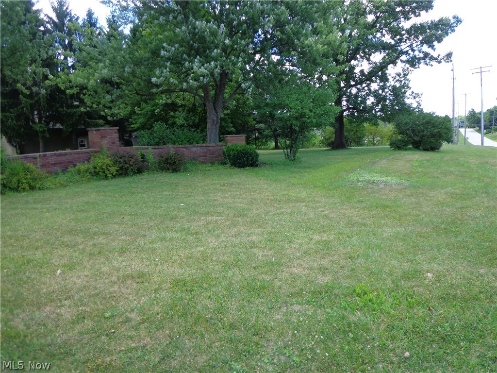 Come build your own house in Wyoga Lake Community. The front entrance lot is being sold off as one lot. The lot is listed as residential and just under a half acre. The community boasts a large recreational lake for boating, park, nature trails, and beach. Two private schools are located within walking distance and highway access is minutes away. Underground electric, public water, sewer, and other utilities available at the street for tie in. Feel free to drive by and call for more questions. Woodridge schools and Cuyahoga falls utilities.