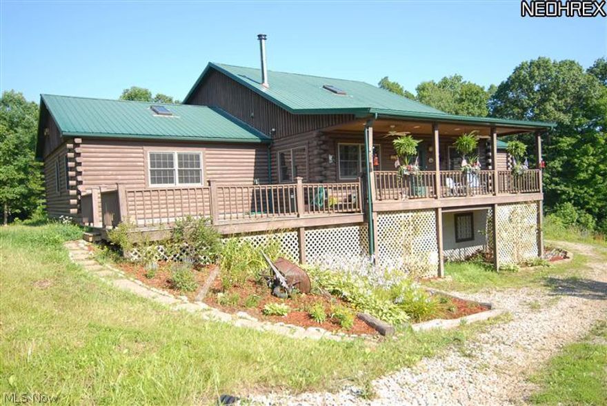 Custom built log home situated on 5 acres m/l designed by Owner/Architect & built by Lincoln Logs. Offering approx 3500 s.f. of living area on the main floor and loft area, plus a walk out basement that could be finished for additional living space.  Basement offers 3 car garage, roughed in bathroom for third full bath. Cathedral ceiling in great room, loft area and master bedroom with a 24' peak. Fireplace in L.R. is made of river rock and goes the full height of the living room wall with an enclosed wood burning firebox rated to heat 2400 sf of floor space with a vent to the master bedroom, could help with your heat bills. Log walls thruout home except in bathrooms. Exposed wood ceilings thruout. First floor laundry room with built in ironing board and door to rear porch. Master bedroom with walk-in closet and master bath, plus two additional bedrooms and full bath on main floor. Open kitchen/dining and great room. Loft. New roof on front section of home 2014, exterior being stripped