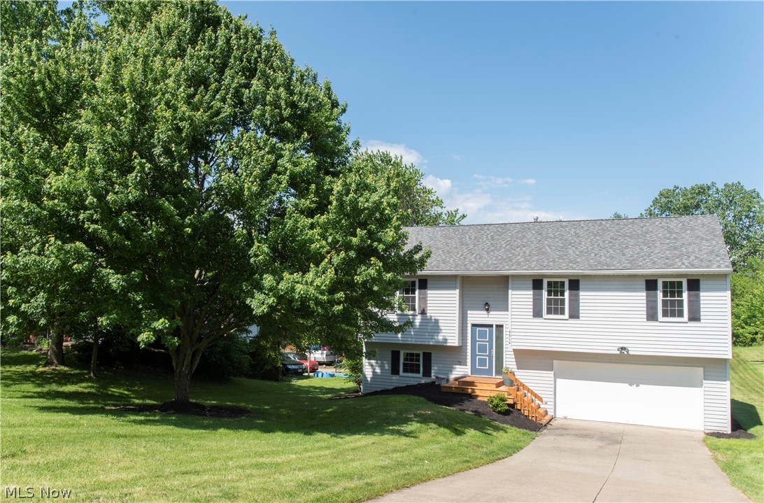 Welcome Home to this exceptionally well maintained property in Medina! This modern, updated and open floor plan is sure to delight. Vaulted great room is open between the beautifully upgraded kitchen with breakfast bar, to the dining room to the living room. Off the dining room is a lovely 12x12 deck overlooking a spacious treed lot. Down the hall you will find great bedroom sizes and ample closet space. Unique bathroom layout includes a Jack and Jill full bath plus an additional half bath. The walk out lower level offers large sunny windows, a spacious family room, another FULL bath, a spacious laundry room and the attached 2 car garage. Many updates throughout including bathroom Reno's 2020, new kitchen counters and cabinets 2018, floors 2017, a/c in 2018, roof in 2012, smart garage door opener 2015, windows 2014, furnace 2011- just to name a few! Nothing to do but move in. Dont miss this one!