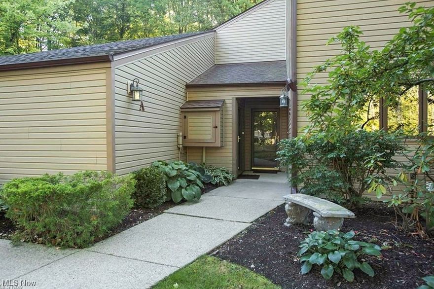 One floor living at it's finest. This Ranch condo is tucked away in The Trees of Bainbridge! This impeccable move-in ready 2 bed, 2 full bath first floor end unit is in a private wooded setting with a long list of updates that include: Anderson windows and patio doors, both bathrooms, carpet in 2nd bedroom, upgraded utility room, stacked stone in the kitchen, stamped concrete patio,wine bar nook made of Granite with a raw edge design, Stools and bar cabinet included. Enter through the front door and into the tiled foyer with a coat closet and bonus custom storage closet. Brazilian cherry engineered hardwood floors lead you into the updated open concept kitchen featuring stainless steel appliances, granite counters, KraftMaid cabinets with pull-outs and lazy susans, up-lighting and under-mount lighting, as well as windows that span the wall for lots of light and a great view of the peaceful courtyard. The kitchen opens to the combined dining and living room with sliders to the private patio, where you can enjoy viewing the private landscaped rear area, patio, lily pond and woods beyond. The bedrooms offer plenty of closet space, including the master with an en-suite bathroom, sliders to the private stamped concrete patio, and scenic views. Both bathrooms have been recently updated with travertine tile, beautifuil lighting and Glass shower doors. The master bathroom has a georgious soaking tub. The attached 2 car garage offers lots of additional storage with built in cabinets, cupboards, and a work table, as well as a huge custom built attic storage space with a pull down ladder not found in other units! All of this and more in a fantastic park-like setting only minutes from Chagrin Falls Village, schools, shopping, parks, restaurants, and highways.
