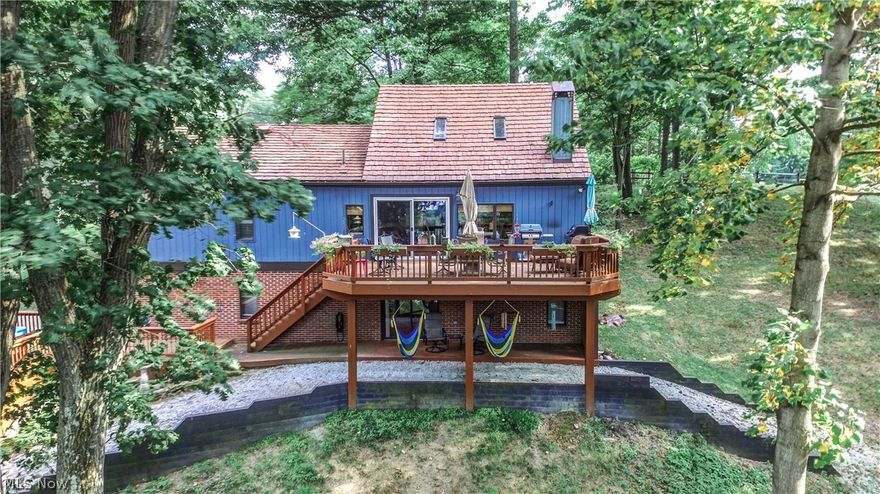 Contemporary style home situated on 4 wooded lot with a year round lake view!  This is a one of a kind piece of property at Lake Mohawk!!  Over an acre of property, loads of privacy, beautiful hardwood floors throughout, updated hickory kitchen, cathedral ceilings, open floor plan, large deck, hot tub, 2 car attached garage and oversized 1 car detached garage.  Lake Mohawk is a private gated community consisting of a 500 acre lake with unlimited horsepower, 3 beaches, tennis courts and a golf course.