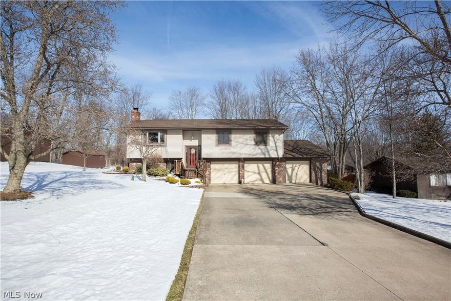 Gorgeous 3 bedroom, 3 bathroom home with 4 car garage and full finished walk out basement! Too many updates to list! Main level boasts an open floor plan with a large kitchen that has granite counters, 2 tiered island,  hickory cabinets, hardwood floors and dining room. Expansive Great room with picture window that overlooks the 2 story foyer. There are 3 large bedrooms and 2 full baths. Master on suite has custom bathroom with double tiled walk in shower. Lower level is another home! There is a bathroom, rec room, laundry room and storage space. Sliders open out to a patio.  Outdoors is an entertainers dream! Private wooded nearly 3/4 acre lot- with 2 tiered deck, horseshoe pit, raised garden beds, a custom shed/playhouse with cable and electric! Endless possibilities with this space! There is also a custom pavilion with water, and electric! Perfect place to hold all of your parties! Newer roof, hot water tank, siding, windows, furnace, electrical just to name a few! Close to Hudson,