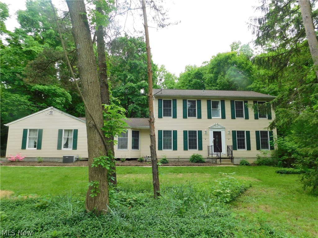 Looking for a home within walking distance of Historic Downtown Hudson? Come see 6400 Elmcrest Drive, a lovely, classic, maintenance free vinyl sided center hall colonial on an almost 1 acre lot with mature trees, private fenced in backyard with a storage shed for all your outdoor garden equipment. Located on end of a quiet, circle cul de sac street. This cozy family home was built in 1971. From the moment you enter the foyer you will notice the new front door with lead glass window, and Luxury Vinyl wood-like floors which extend into the large, eat-in Kitchen with white painted cabinets, granite counters and stainless steel appliances. There is a formal Living and Dining Room off the Foyer. The Family Room has a bayed window, WB fireplace with wood stove insert that is flanked by built in shelves and cabinets. A Half Bath and door to the backyard are found off the back hallway which leads to the oversized 2 car garage. Upstairs you will find 4 Bedrooms and 2 Full Baths which hav