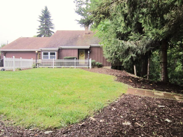 Remarkable, one-of-a-kind architectural design for this region! Exterior & interior configuration custom designed to maximize the breathtaking wooded views. Once you enter this property you'll forget you're minutes from so many conveniences. Striking entry with unique features at every turn! Great room features a soaring wood beamed ceiling leading to an open upper loft space, phenomenal custom glass & patio doors, open riser staircase, curved brick fireplace & mantel. Oak kitchen w/ snack bar, pull out drawers, glass fronts. First floor owner's suite has a cozy sitting area with corner windows/accent wood ceiling as well as access to the main bath w/ dual sinks & vanity. Incredible upper level loft leads to balcony. The entire second floor has vaulted wood ceilings. Large bedroom up has private full bath & walk in closet. Full walk-out lower level is great for entertaining. Family room provides two-sided fireplace, beamed ceiling & dual patio doors overlooking the scenic setting! Lowe