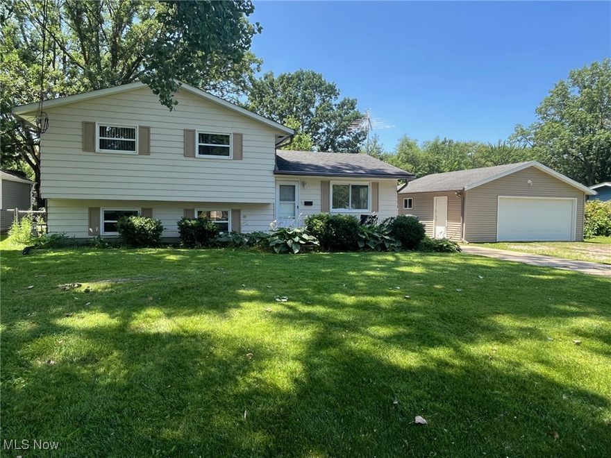 Opportunity knocks to own this 3 bedroom, 2 full baths split level home in desirable area of North Ridgeville. Spacious main level  living room with picture window. Dining area has a patio door that leads to a partially covered deck perfect for entertaining and summer BBQ's. Cheery white kitchen with appliances that stay. Bedrooms are carpeted, master bedroom has own entry leading to full bath. Lower level family room with brick wood burning fireplace.  Full bath with stand up shower in lower level and across the hall is the laundry/utility room with washer dryer. Leaf Guard gutters and Home has oversized two car garage on extra wide lot, mostly fenced. Convenient to shopping centers, dining and interstates.   Come take a look and make it your own.