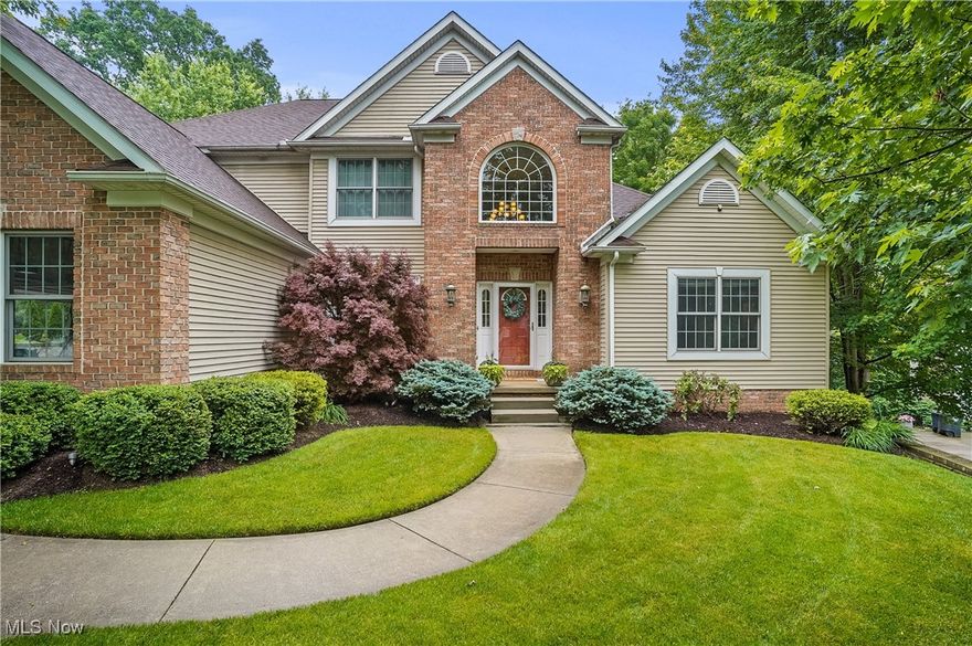 Welcome home to the idyllic tree lined streets of the coveted High Hampton neighborhood in Cuyahoga Falls. This 4-bedroom 3.5-bath home offers an abundance of space with contemporary upgrades throughout and a versatile layout. Walk into your two story foyer adjacent to the formal dining room with detailed chair rails. The open concept leads you in to the 18 foot coffered ceiling great room with ample natural lighting from the floor to ceiling windows. The light and bright chefs kitchen has all new tiled backsplash and quartz countertops with new matching SS appliances. Enjoy coffee in your sunroom with views of the expansive wooded treeline and back deck. Also conveniently located on the first floor is the sprawling primary bedroom and bathroom with plenty of room for a king-sized bed and sitting area or private workspace. Upstairs you will find three generously proportioned bedrooms with walk-in closets for ample storage and a Jack-and-Jill bathroom. The fully finished walkout lower level truly expands the possibilities of this home with an extra room perfect for your home office or a 5th bedroom. Stay active in the dedicated gym or indulge in leisure with a cutting-edge golf simulator or theater room ideal for sharpening your swing or enjoying immersive movie nights. Outside a beautifully landscaped wooded lot with a spacious deck invites summer bbq's, phenomenal bird watching or peaceful quiet evenings under the stars. All new matching luxury carpet on all 3 levels in 2025, water heater in 2024, new roof and kitchen in 2020. Home has all new paint throughout.
